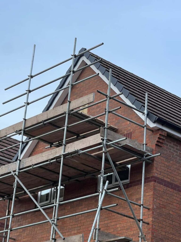 This is a photo of a roof which has just been repaired. There is a scaffold located at the gable end for access onto the roof. Works carried out by Sudbury Roofing Repairs