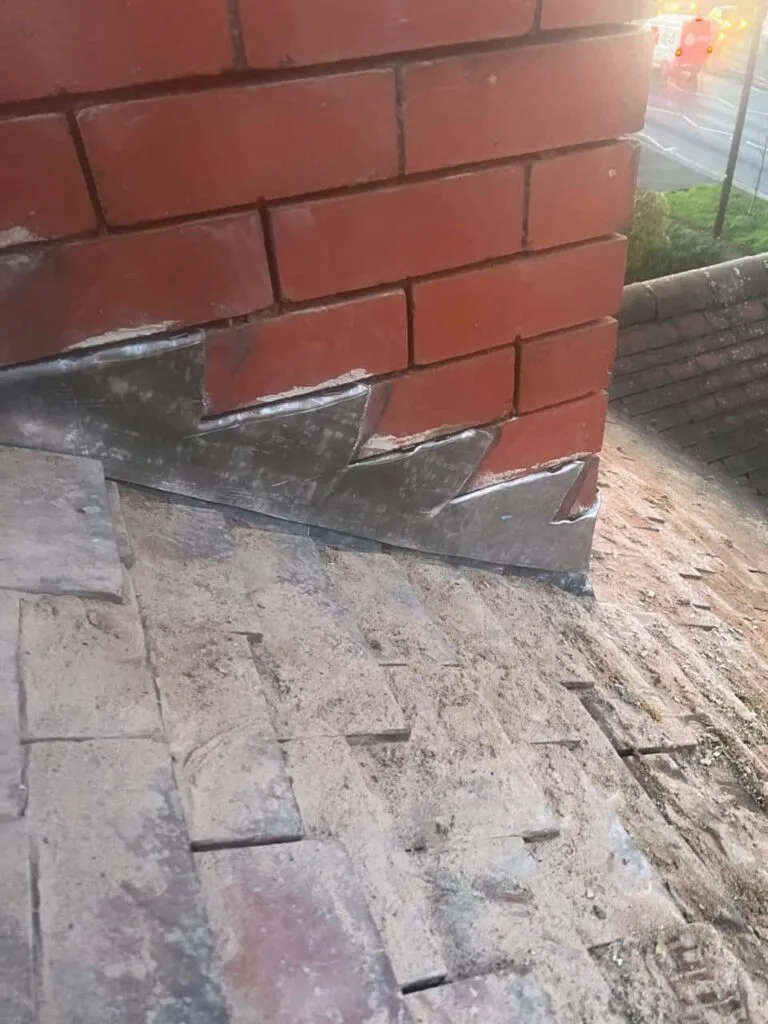 This is a photo of new leadwork being installed around an old chimney. Works carried out by Sudbury Roofing Repairs
